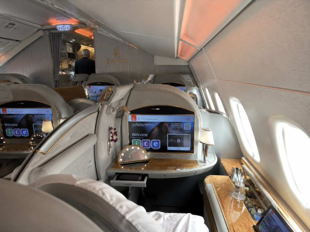 Luxury Emirates business class cabin with private suites and premium airplane interior