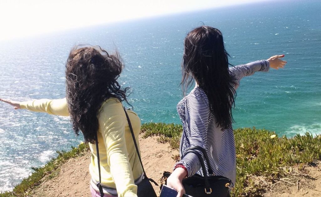 Women travelling together during a girls’ trip by the ocean coast