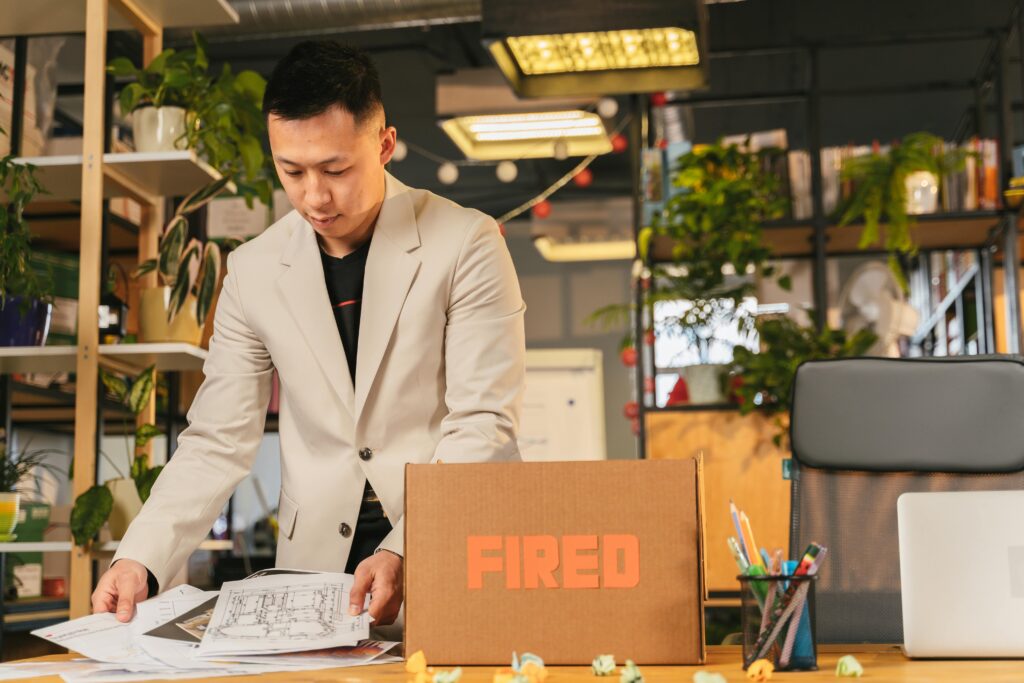 Man packing office belongings after being fired from work and losing his job