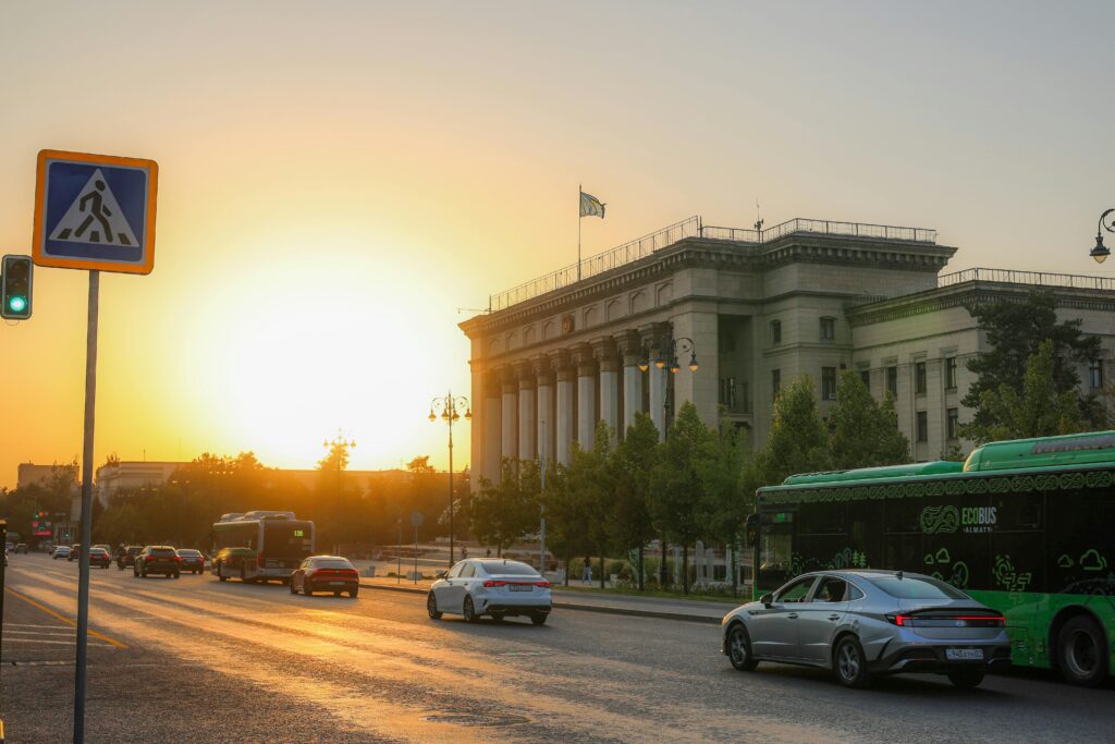 Modern city street at sunset with public transport and urban architecture