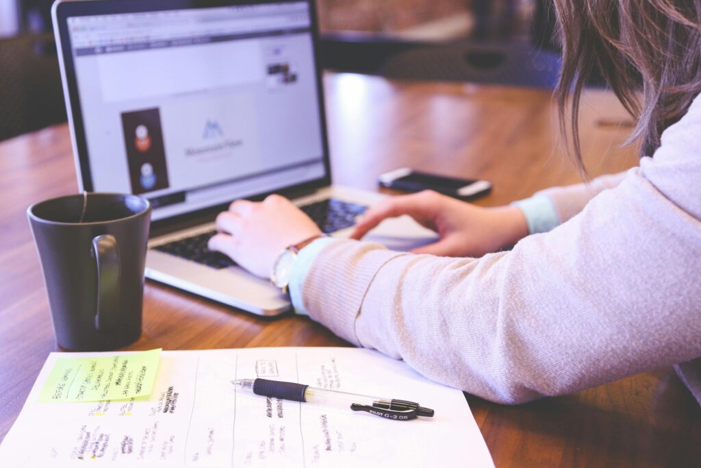 Woman searching and applying for jobs online from home office laptop