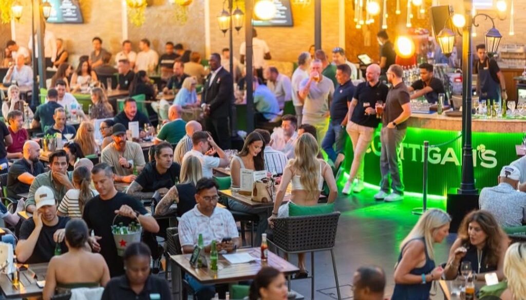 People socialising at McGettigan’s pub in Dubai during evening drinks