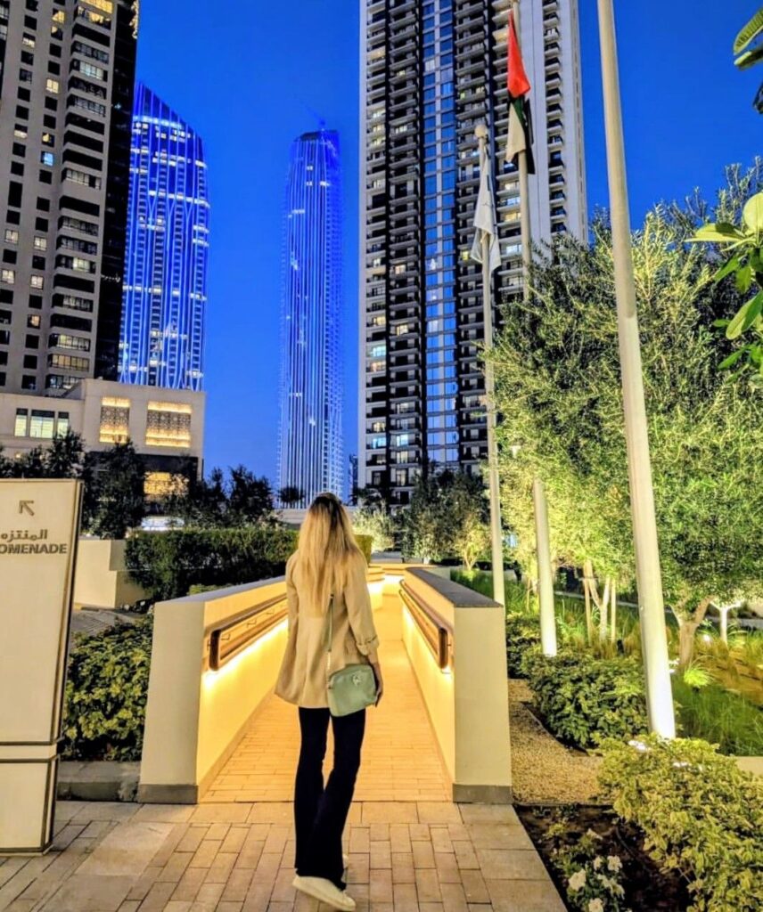Woman walking through Downtown Dubai while living and working remotely in the UAE