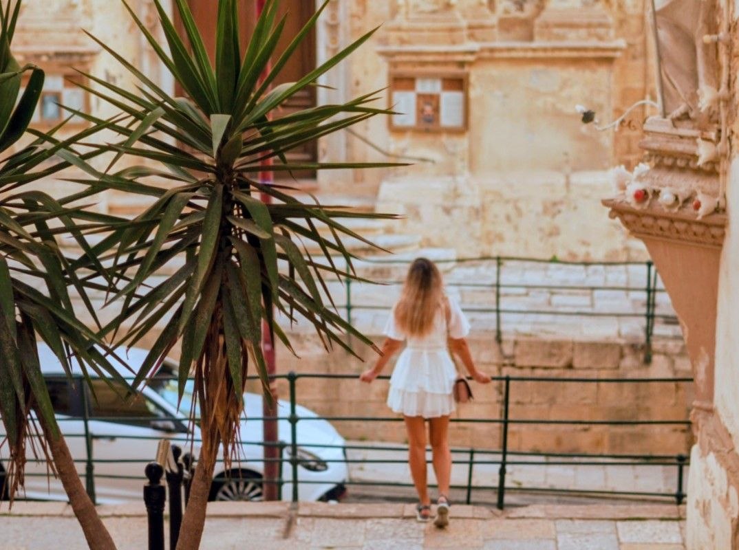 Woman enjoying the streets of Malta during summer travel