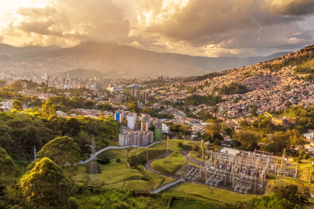 Medellin city skyline surrounded by green mountains in Colombia, a growing digital nomad destination and affordable alternative to Bali
