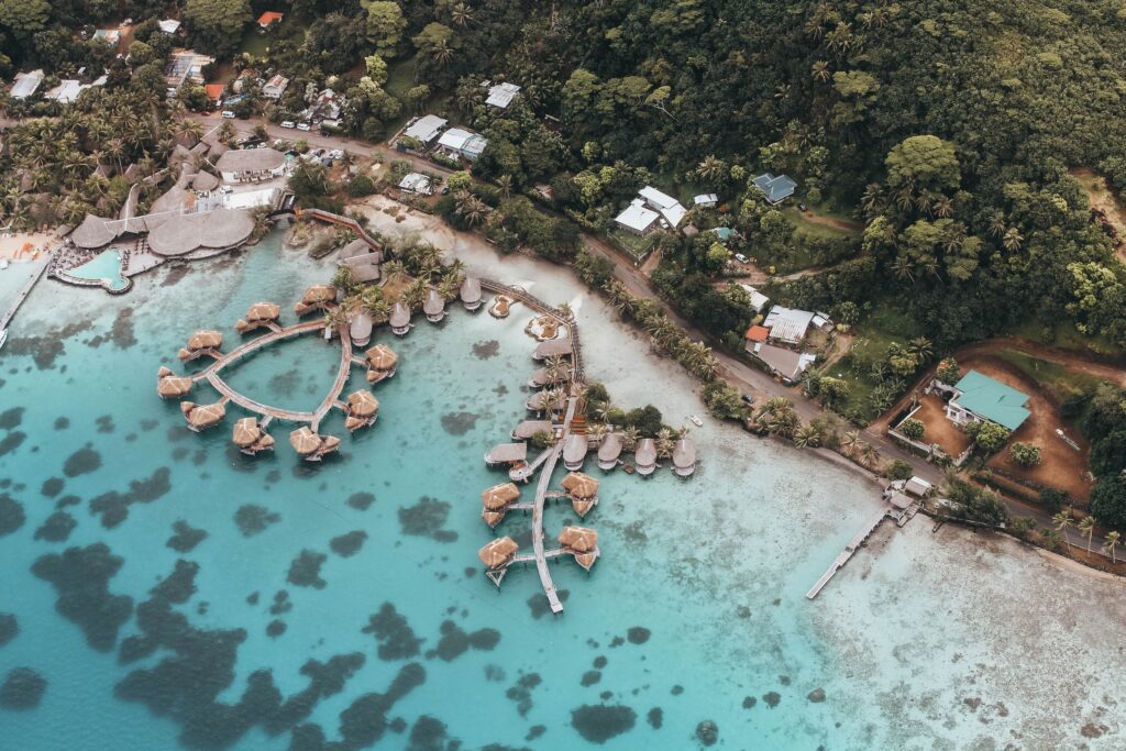 Aerial view of the coastline and waterfront homes in Vanuatu, showing everyday island living and tropical landscapes.