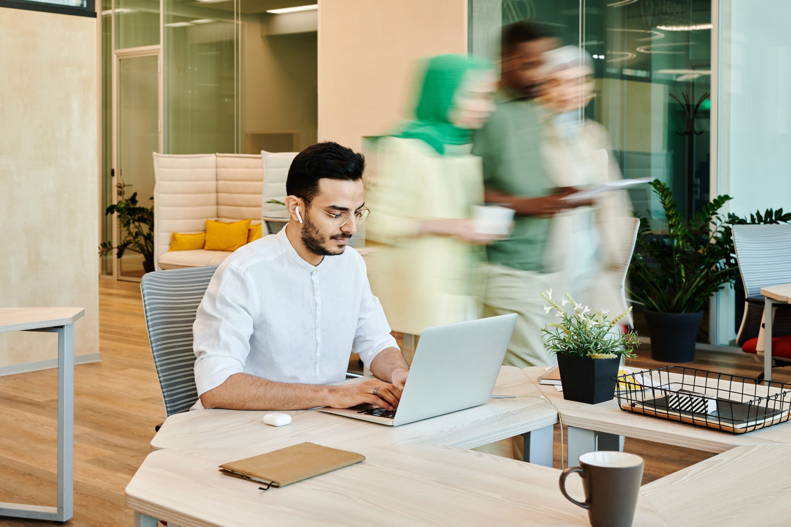 Remote worker using a laptop in a modern coworking space in Dubai