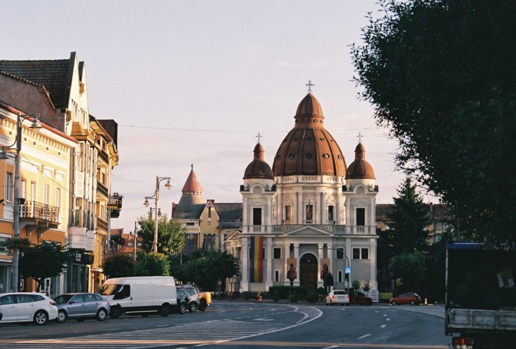 Historic church and city street in Romania at sunset