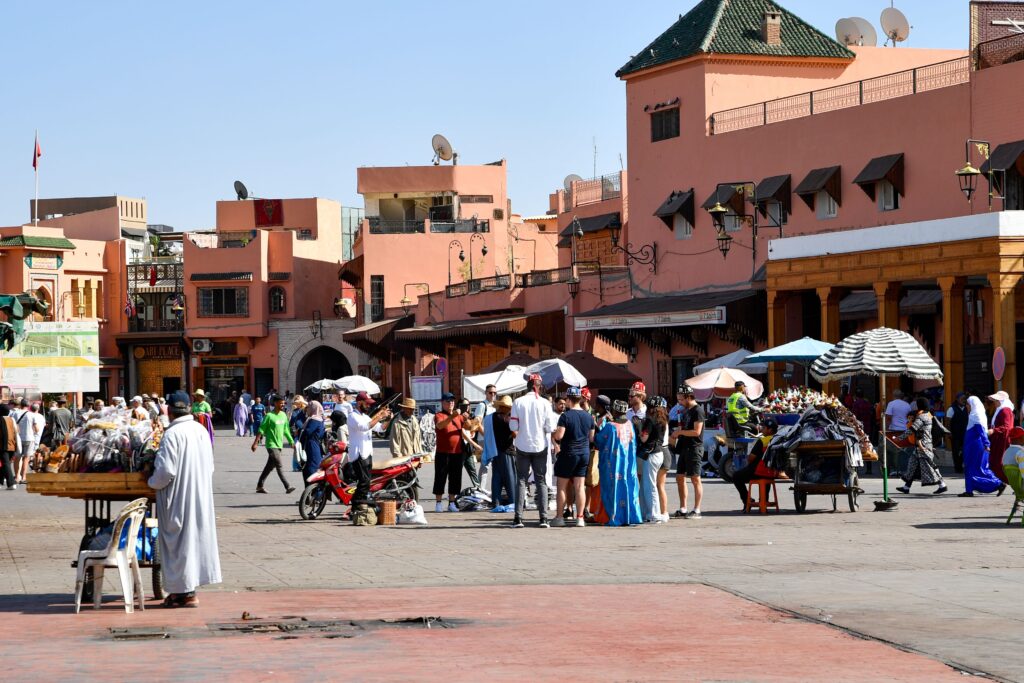 Busy public square in Marrakech, Morocco, showing everyday life and the cultural environment where French and Arabic are widely spoken.
