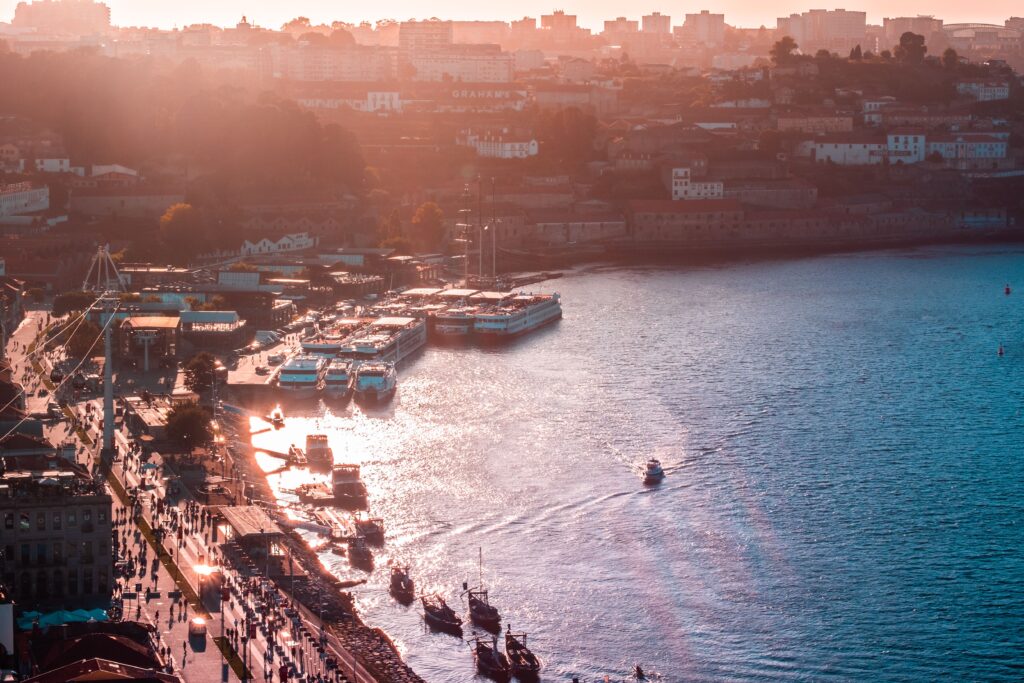 Porto waterfront at sunset along the Douro River, a scenic and affordable European destination for digital nomads.