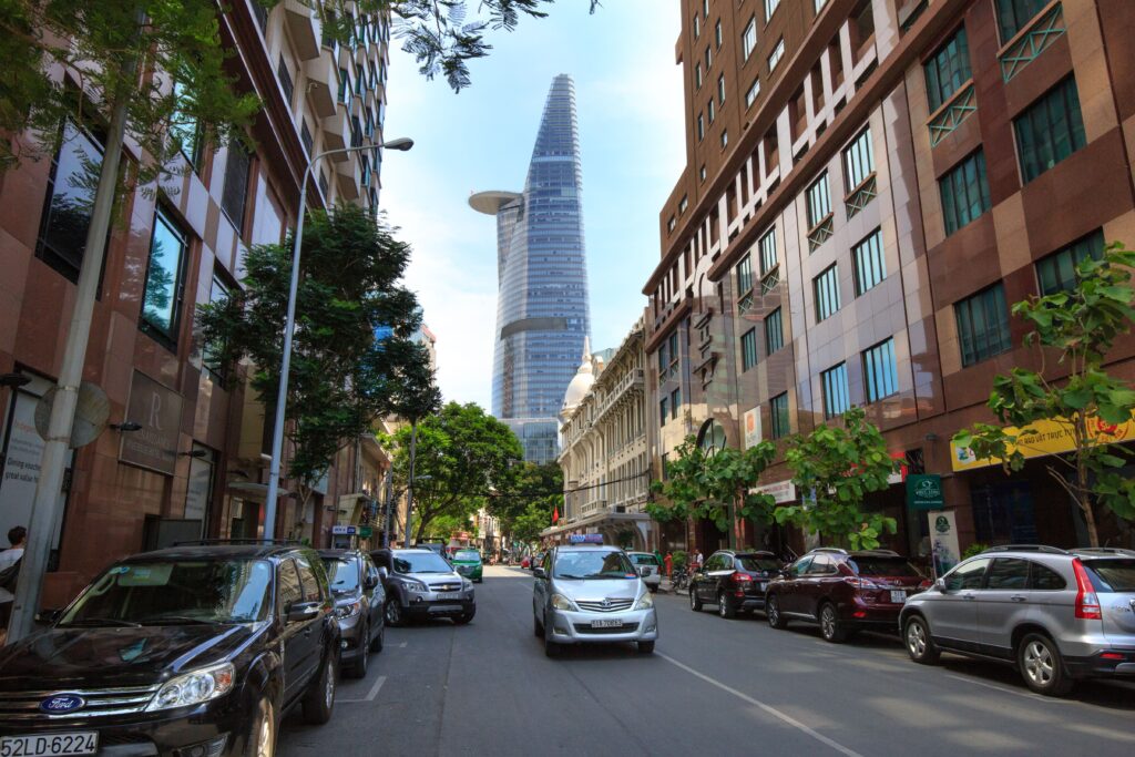 Street view in District 1, Ho Chi Minh City, with the Bitexco Financial Tower in the background