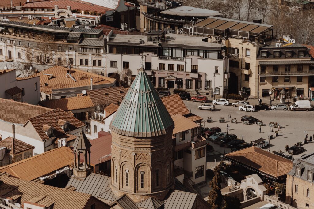 Aerial view of Tbilisi's Old Town with traditional rooftops and historic church