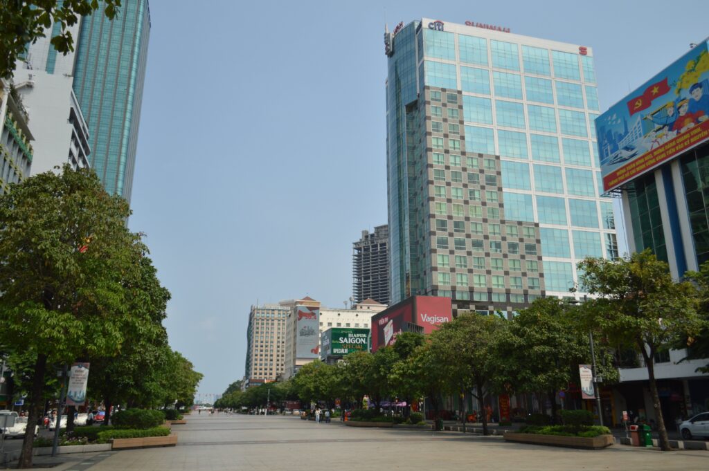 Nguyen Hue Walking Street in Ho Chi Minh City with modern office buildings and tree-lined boulevard