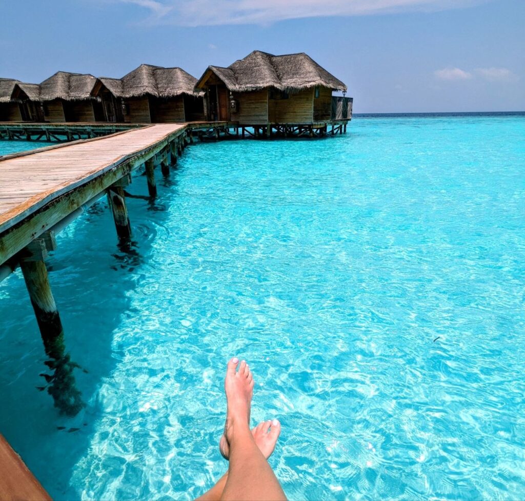 Overwater villas and crystal-clear lagoon at a luxury resort in the Maldives visited on a day pass.