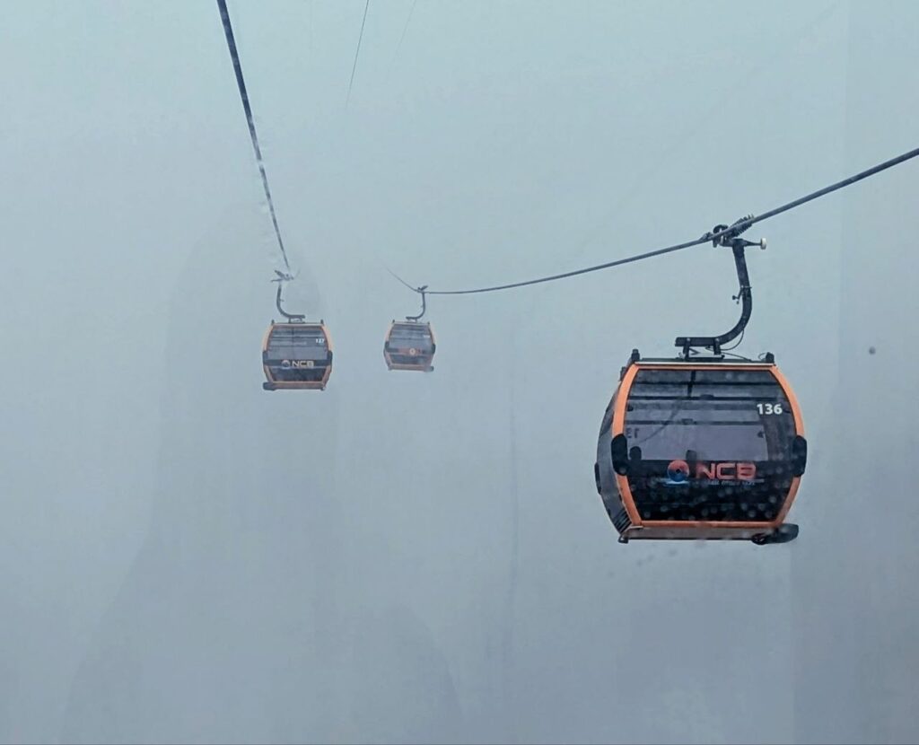 Ba Na Hills cable cars disappearing into dense fog during rainy weather in late September, Da Nang, Vietnam