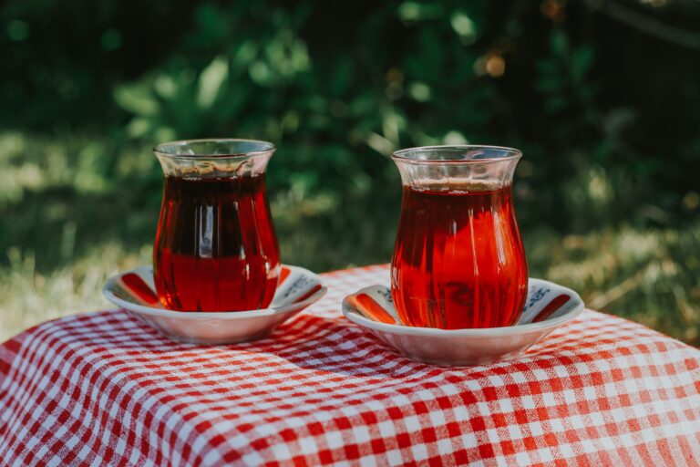 Two glasses of traditional Turkish tea served in tulip-shaped glasses