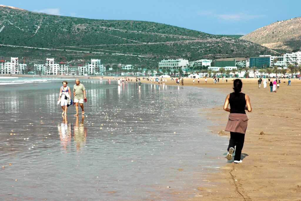 Agadir beach in Morocco with people walking along the coast