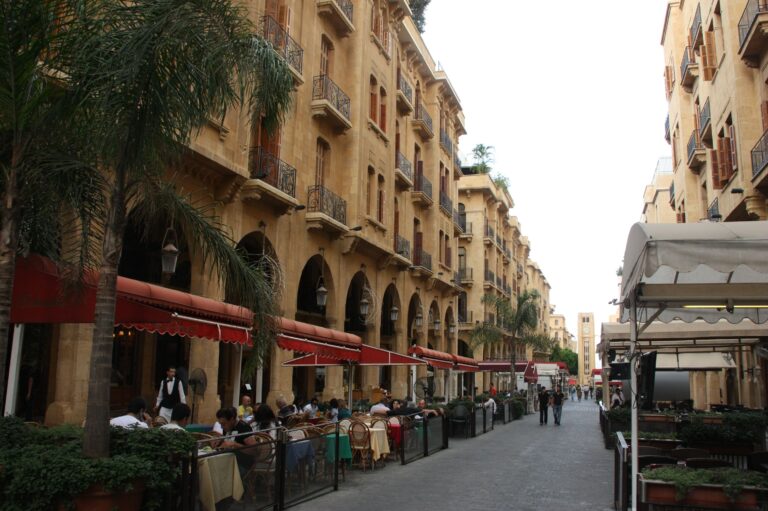 Pedestrian street in downtown Beirut lined with cafés, restaurants and historic sandstone buildings.