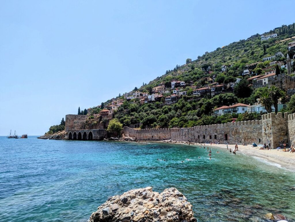 View of Alanya city center, the historic castle walls, and Cleopatra Beach on Turkey's Mediterranean coast