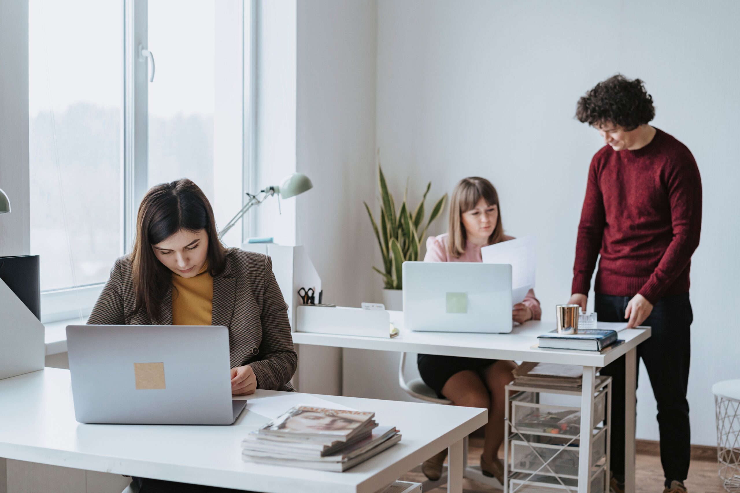 Coworker sitting alone while colleagues talk in the office