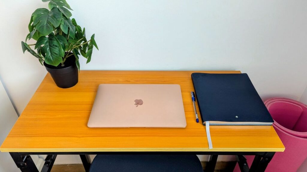 Small folding table used as a home office desk in a studio apartment