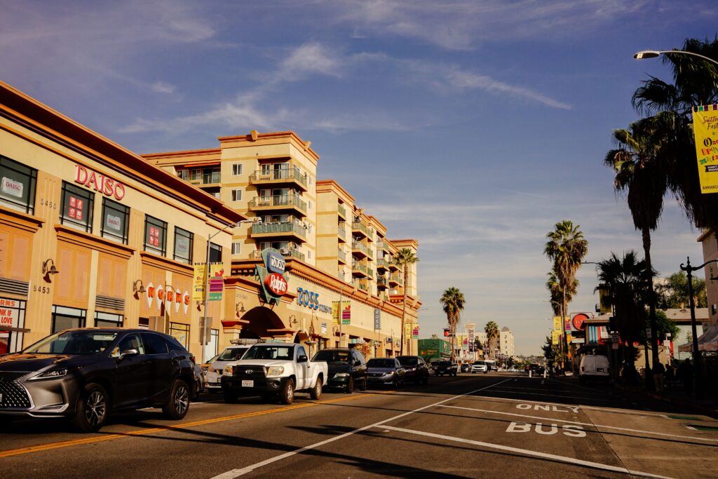 Palm-lined street in Culver City, Los Angeles, with shops, restaurants and a bus lane