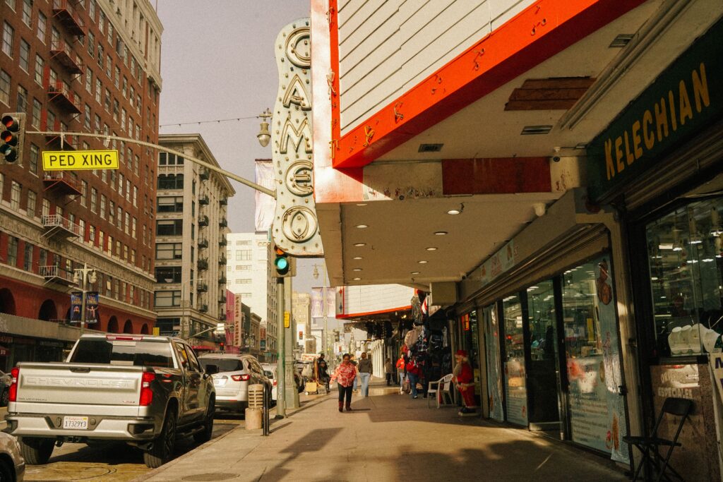 Downtown Los Angeles sidewalk with shops and the historic Cameo Theatre sign